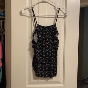 Tank with ruffles on edges.